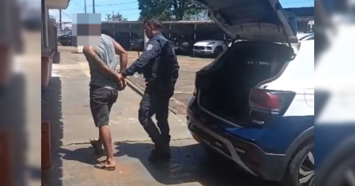Homem sendo abordado por policiais durante festa infantil em Apucarana
