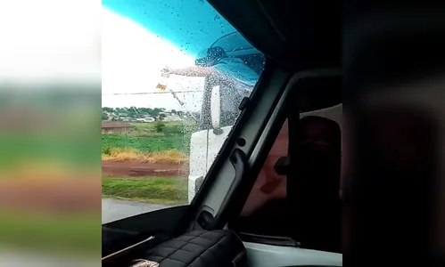 Vídeo registra imprudência de caminhoneiro que está 'pendurado' em cabine; Assista