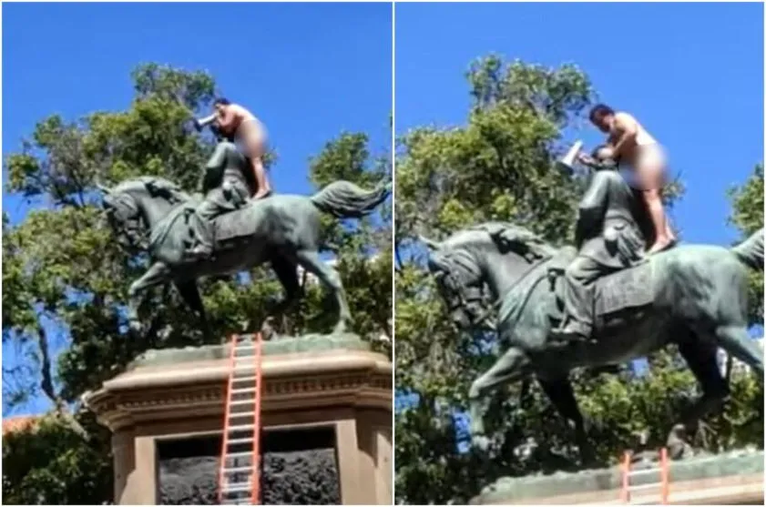 Homem nu sobe em estátua e diz: “só desço após ser vacinado"