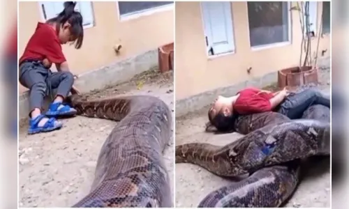 Menina viraliza ao brincar com cobra gigante; assista
