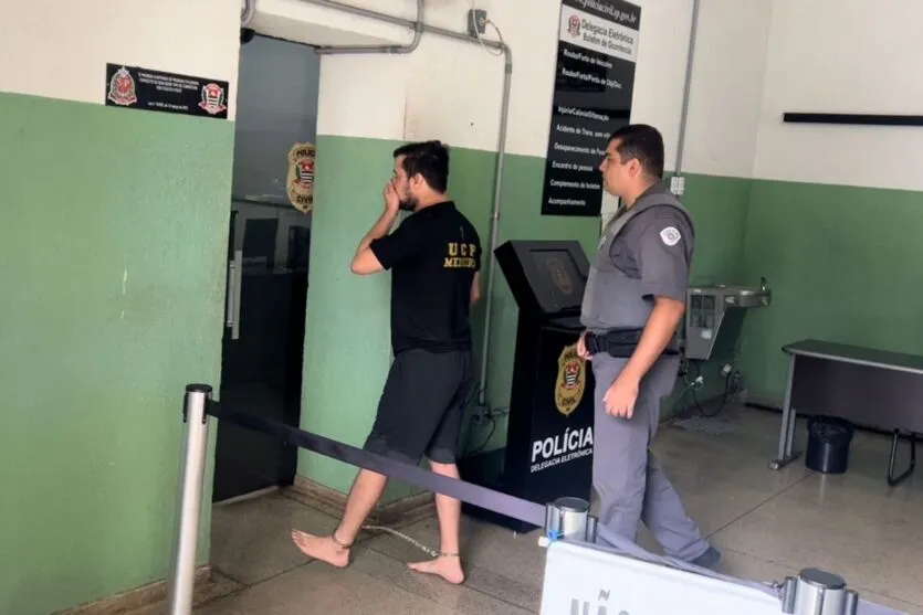 Momento em que o comediante era conduzido à autoridade policiai, preso em flagrante por agredir a mãe