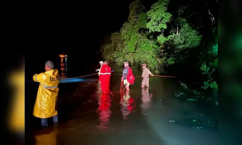 Família tenta atravessar estrada alagada e carro é arrastado para rio