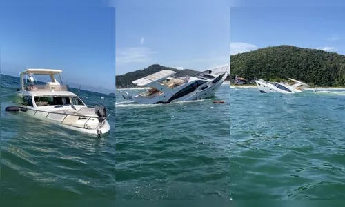 Lancha com duas pessoas dentro afunda em praia; veja vídeo