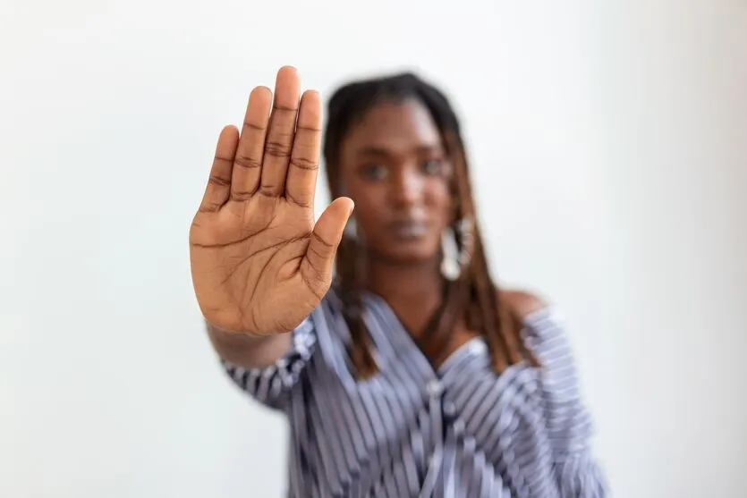 woman raised her hand for dissuade, campaign stop violence against women. African American woman raised her hand for dissuade with copy space