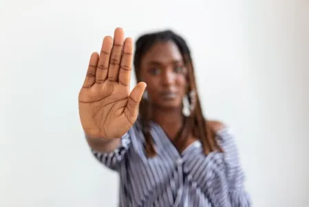 woman raised her hand for dissuade, campaign stop violence against women. African American woman raised her hand for dissuade with copy space
