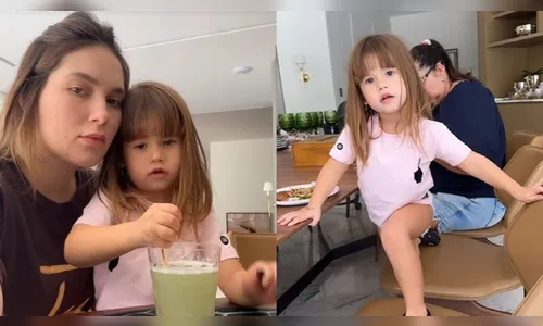 A pequena aparece no colo da mãe