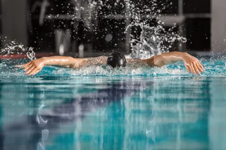 Male swimmer swimming the butterfly stroke in a pool