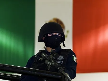  Policial federal observa apresentação de traficante preso no Estado de Durango, no México; militares mataram 12 supostos criminosos nesta quinta