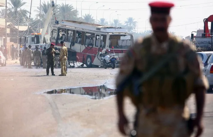  Policiais iraquianos inspecionam ônibus que carregava peregrinos xiitas iranianos e foi atingido por carro-bomba