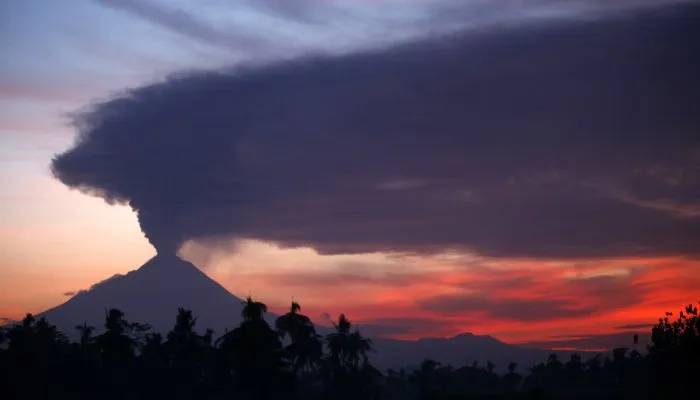  Vulcão Merapi solta cinzas e fumaça durante por do Sol na ilha de Java, na Indonésia, neste sábado (13)
