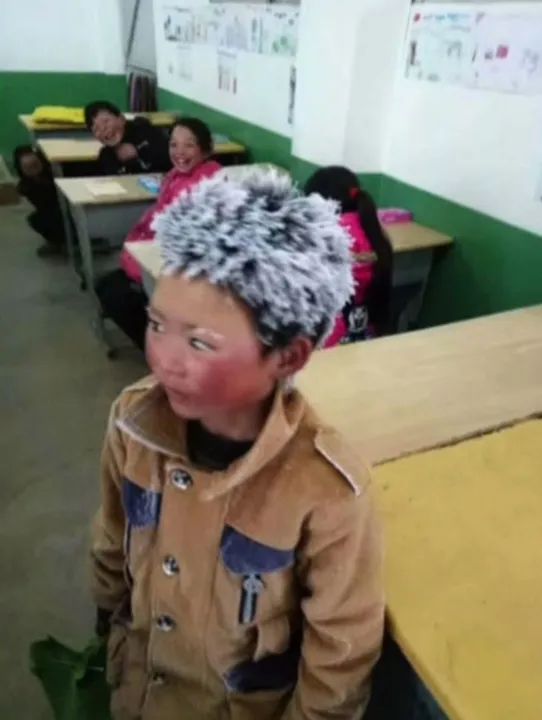 O garoto chinês Wang Fuman, de 8 anos, caminhou 1 hora e meia no frio de 9 graus negativos e chegou à escola com os cabelos congelados (Foto: Reprodução/TV Globo)