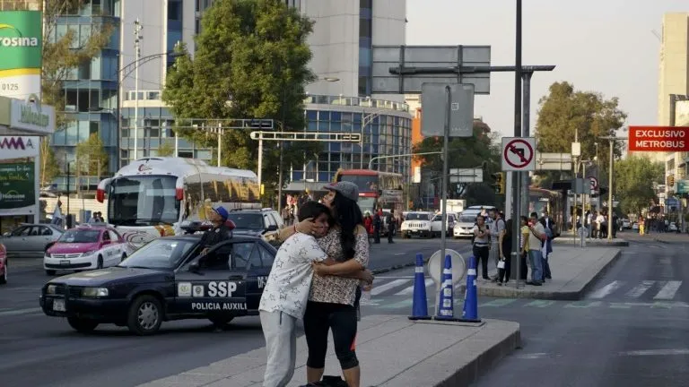 Mulher abraça um menino no momento de um terremoto na Cidade do México em 16 de fevereiro de 2018 - AFP